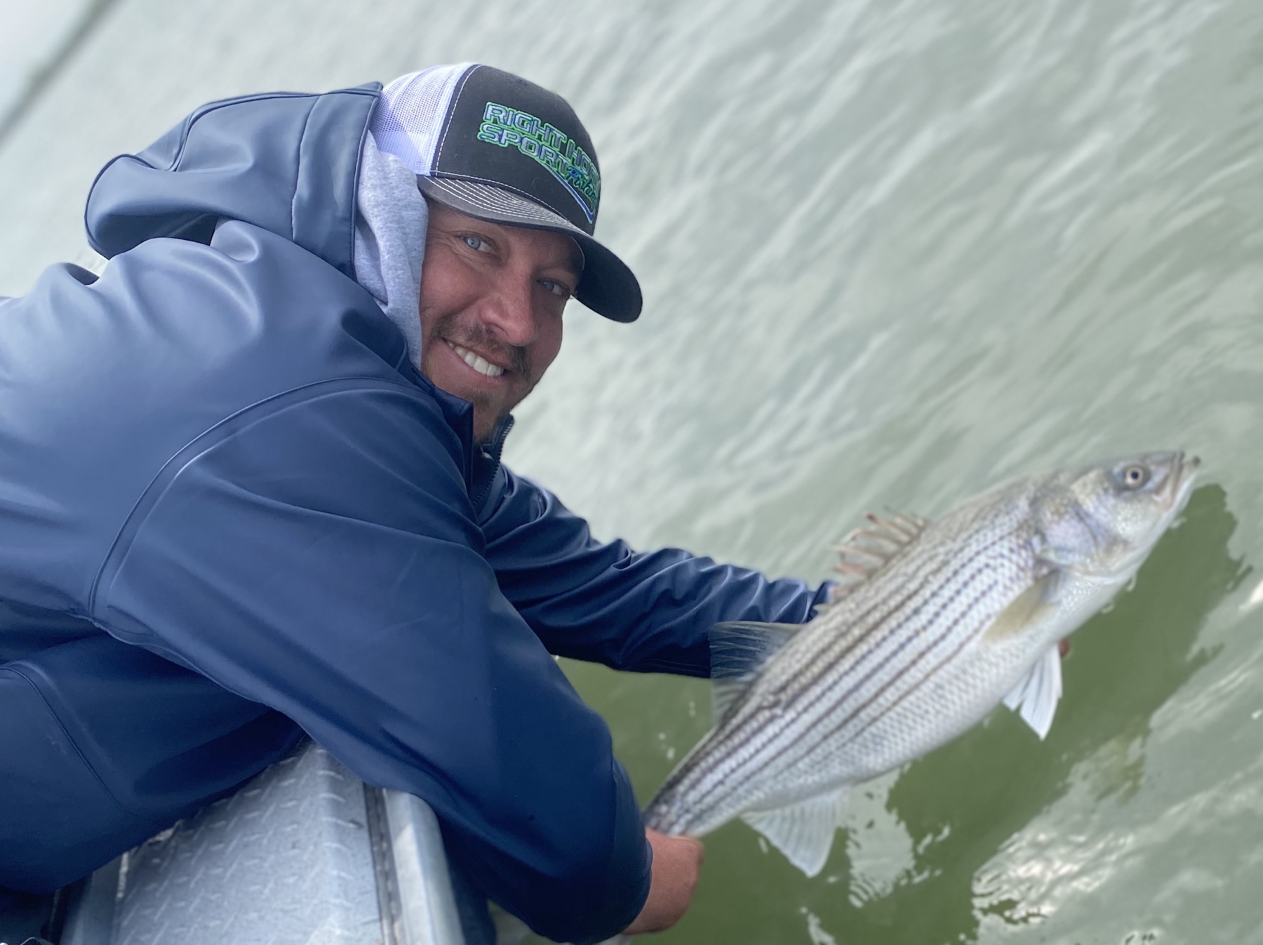 Capt. Jay Lopes releasing a striped bass