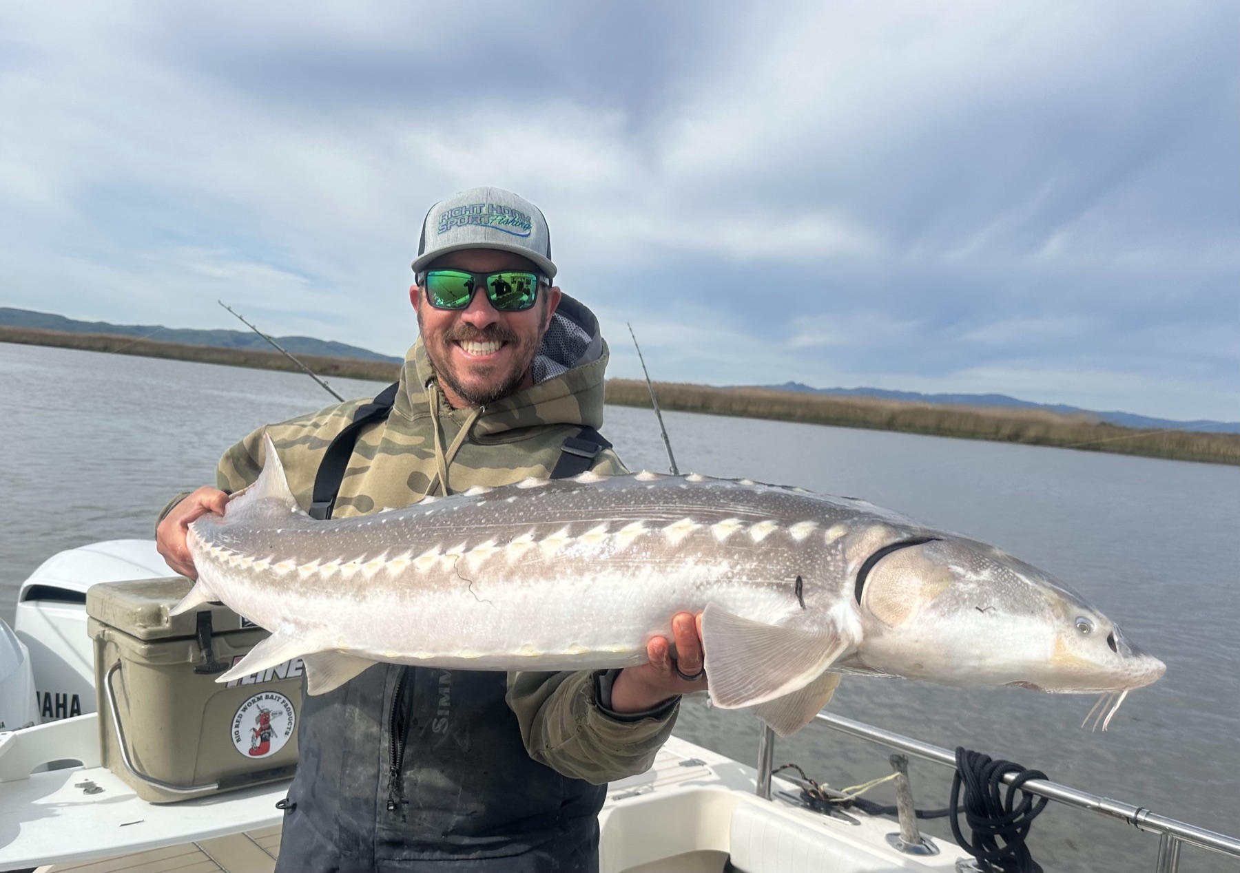 Capt. Jay Lopes holding a large sturgeon